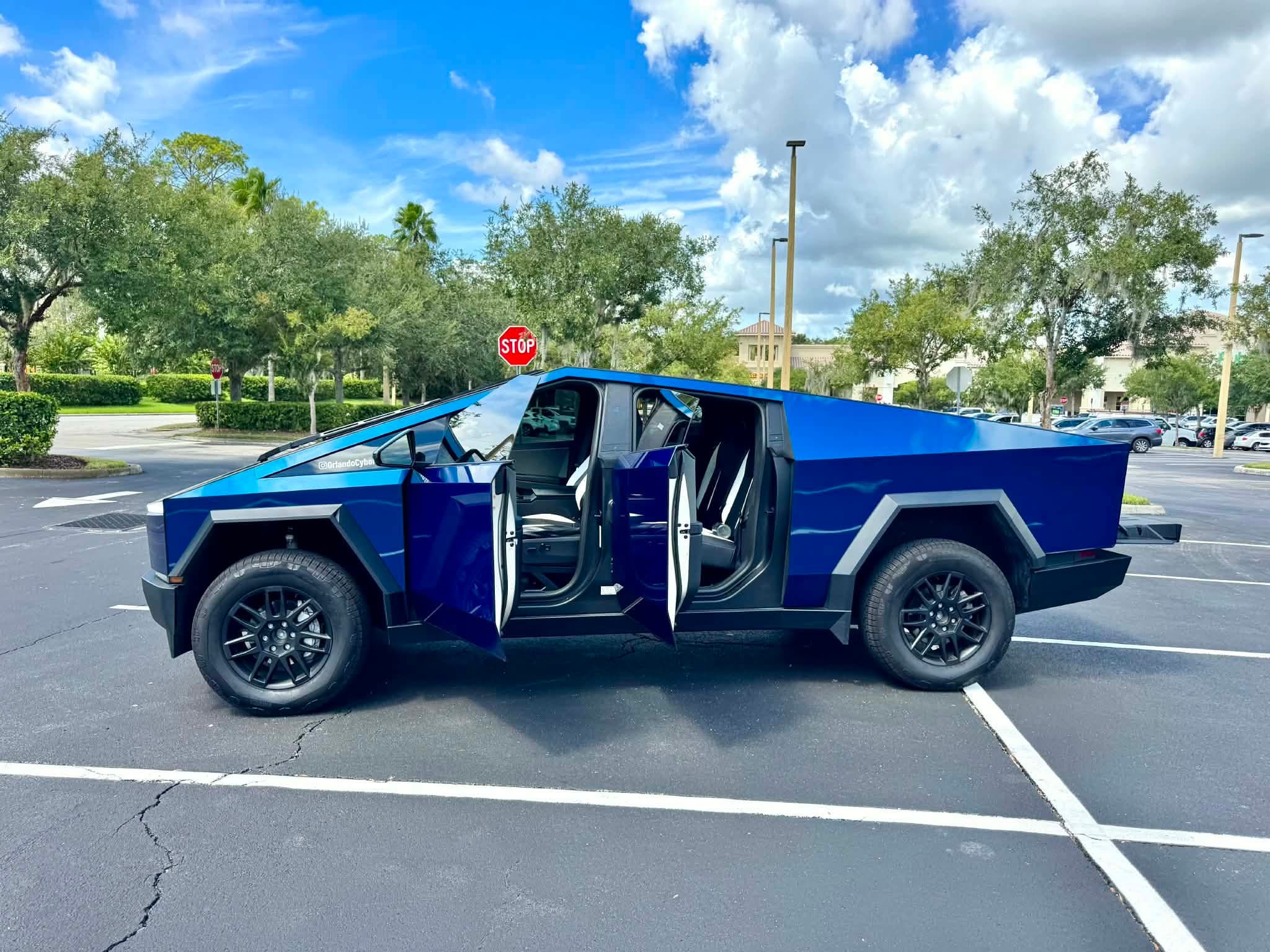 Blue G-Force Ridez Cybertruck with all doors open, ready for boarding